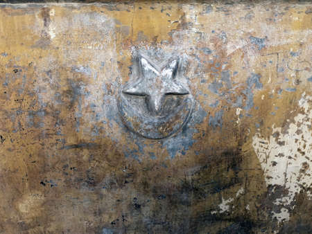 Turkish flag crescent and star embossed on old wall of a fountainの写真素材