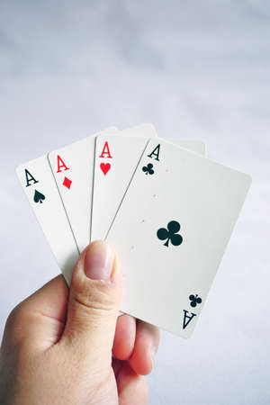 Poker cards with assorted combinations in man hand close up and isolated backgroundの写真素材