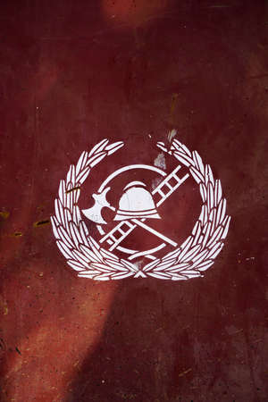 Retro fire fighter symbol on red extinguisher drawer close up viewの写真素材