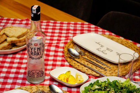 10 October 2020 Eskisehir Turkey. Yeni Raki Turkish raki and roasted bonito fish on the tableのeditorial素材