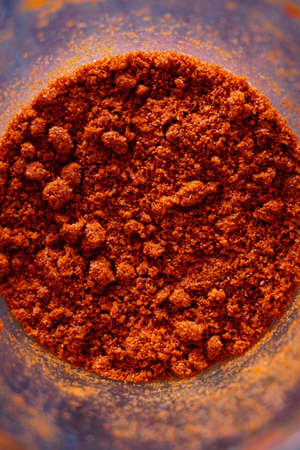 Powdered red pepper in the jar close up viewの写真素材
