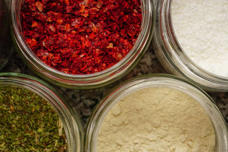 Assorted seasoning spice in the jars in the kitchen close up viewの写真素材