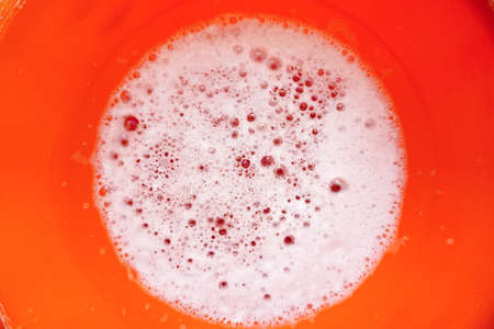 Detergent water in the orange container close up viewの写真素材