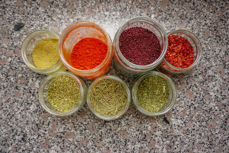 Assorted seasoning spice in the jars in the kitchen close up viewの写真素材