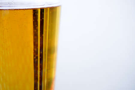 Fresh beer with bubbles in the pint close up viewの写真素材