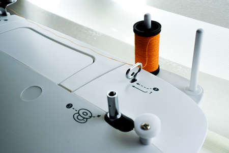 Sewing machine needle bobbin and stitch settings details close up viewの写真素材