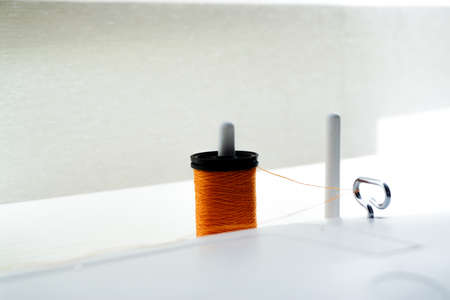 Sewing machine needle bobbin and stitch settings details close up viewの写真素材