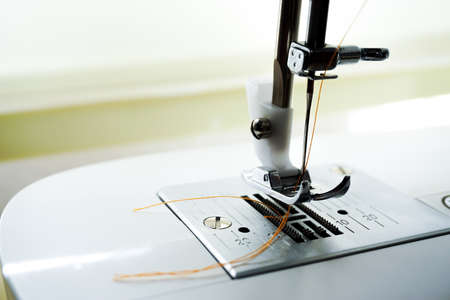 Sewing machine needle bobbin and stitch settings details close up viewの写真素材