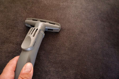 Vacuum cleaner at home in hand close up viewの写真素材