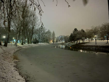 Frozen Porsuk river in Eskisehir at Kanlikavak park at night snow scenesの写真素材