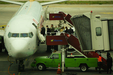 7 May 2022 Ankara Turkey. Boarding Pegasus airlines plane with ramp on Esenboga airportのeditorial素材