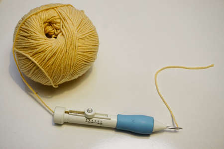 Punch knitting tools with yarn on isolated backgroundの写真素材