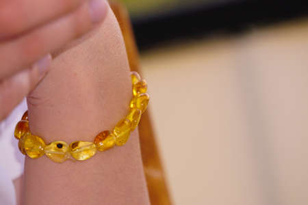 Amber bracelet on woman hand close up viewの写真素材