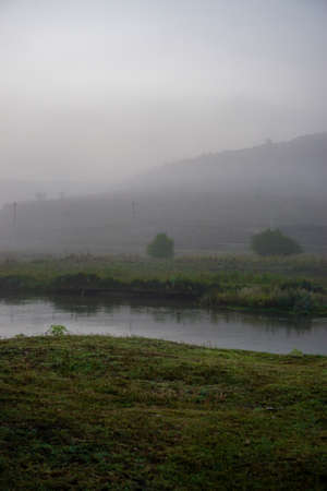 Camping in the nature waking up into a misty sunriseの写真素材