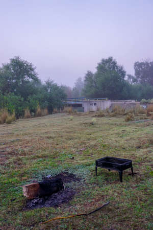 Camping in the nature waking up into a misty sunriseの写真素材