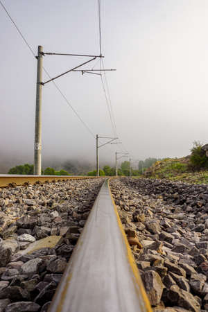 Railroad in the nature on a foggy morningの写真素材