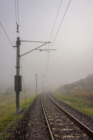 Railroad in the nature on a foggy morningの写真素材