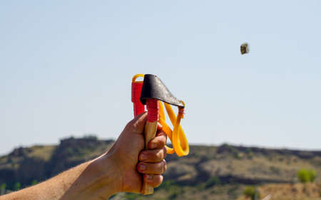 Man using spear thrower throwing rock nature amusementの写真素材