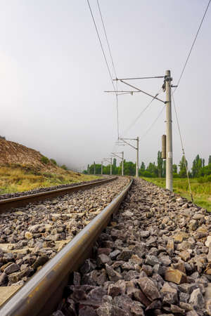 Railroad in the nature on a foggy morningの写真素材