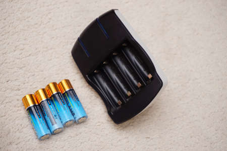 31 July 2022 Eskisehir Turkey. Battery charger with batteries close up viewの写真素材