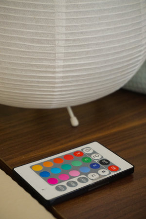 Rgb led bulb remote on wooden table close up viewの写真素材