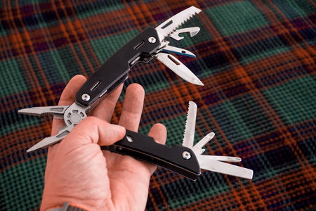 Man holding multi tool in hand close up viewの写真素材