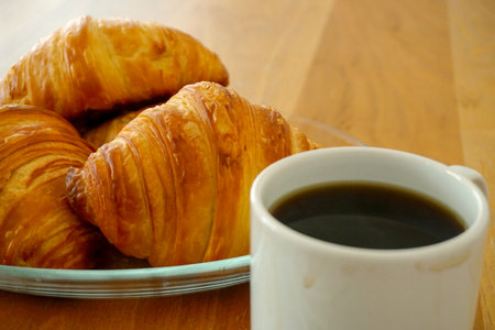 Croissant and coffee breakfast appetizers close up viewの写真素材