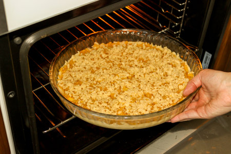 Sweet dough apple pie preparation in the kitchen close up viewの写真素材