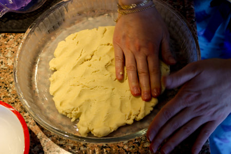 Sweet dough apple pie preparation in the kitchen close up viewの写真素材