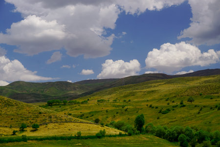 Scenic fields and meadows in Erzurum Cat road in Turkey on a cloudy dayの写真素材