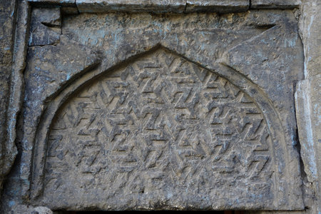 13 July 2025 Erzurum Turkey. Historical clock tower tepsi minaret from Saltuk era in city center with architectural details and war artifactsの写真素材