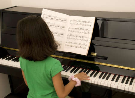 Asian Girl Practicing Pianoの写真素材