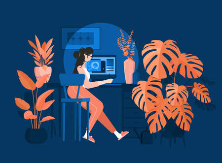 Girl freelancer sits at a desk and draws on a tablet. Efficient and productive work at home at...