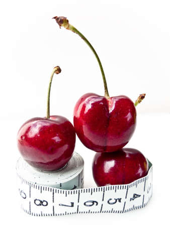 Cherries on a measuring tape. Health concept.の写真素材