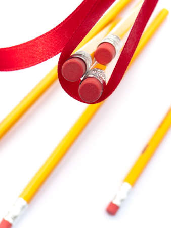 Pencils hanging by a ribbonの写真素材
