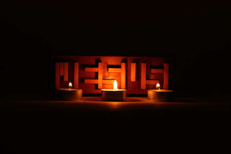 Jesus puzzle surrounded by three candles, symbolizing the Trinity.の写真素材