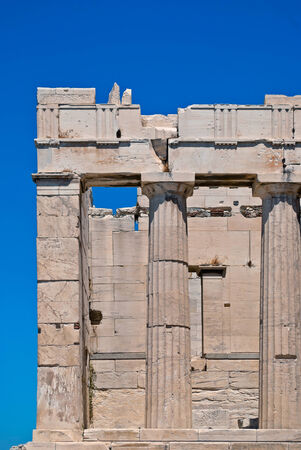 Fragment of the ruins of an ancient temple with columns Akropolyav Athens against the sky on a sunny summer day の写真素材
