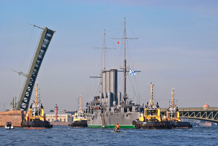 Towing the cruiser \"Aurora\" with its Parking lot near the College named Admiral Makarov on the Neva River under Kirov bridge for major repairs to the docks of the island of Kronstadt.の写真素材