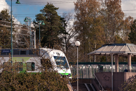 Railway platform by train in the Finnish town of Jarvenpaa.