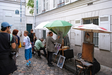 Paris, France, June 21: Paris artists paint portraits of Parisians and guests of the city in a cozy corner of the place du Tertre in Montmartre, 21 June 2012.のeditorial素材
