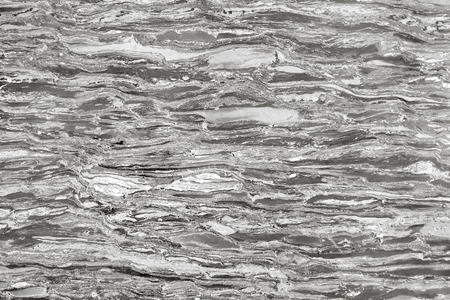 Fragment of a marble slab of gray color for use as an abstract background.