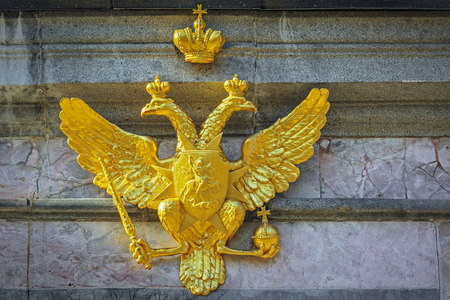 The gilded figure of a double-headed eagle with the crown of the Russian Empire, fortified on a pedestal of marble.の写真素材