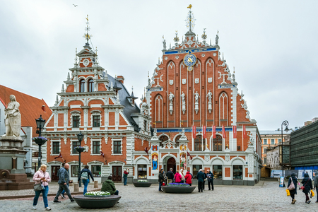 Riga, Latvia, May 02: Tourists walking through the square in front of the building of the House of Blackheads in the old part of Riga, May 02, 2019.のeditorial素材