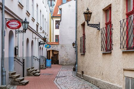 Riga, Latvia, 02 may: Cozy and quiet street paved with cobblestones and red tiles in the old part of Riga, 02 may 2019.のeditorial素材