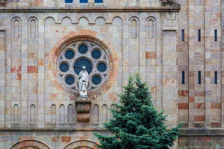 Sculpture on the wall of the building of the new Synagogue in the city of Szeged against the background of a round window.の写真素材