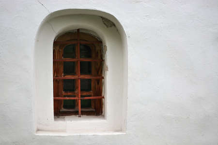 Window in a niche on the plastered wall of the Church of John the Baptist in the city of Veliky...