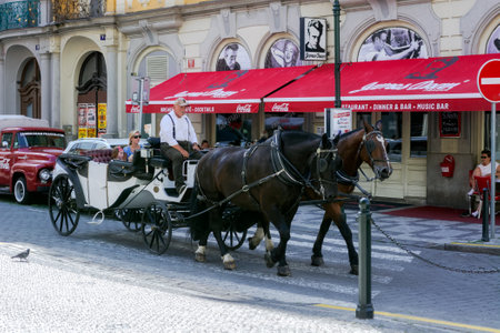 Prague, Czech Republic, July 26: Tourists and visitors of the city make walks on a horse-drawn carriage through the streets of the city of Prague, July 26, 2022.のeditorial素材