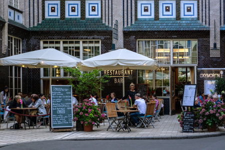 Berlin, Germany, July 20: Residents and guests of the city relax in a cozy restaurant located in a courtyard in Berlin on July 20, 2023.のeditorial素材