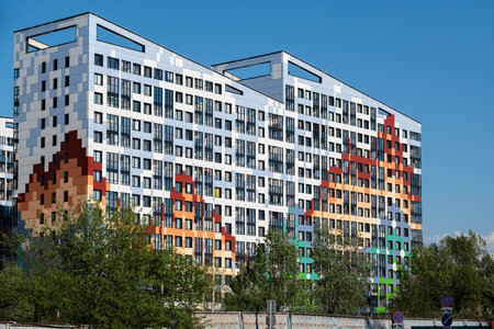 Original apartment building in the new buildings against the blue sky.の写真素材