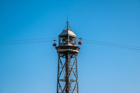 Fragment of a cable car with a tower, against the backdrop of a cloudless blue sky.の写真素材
